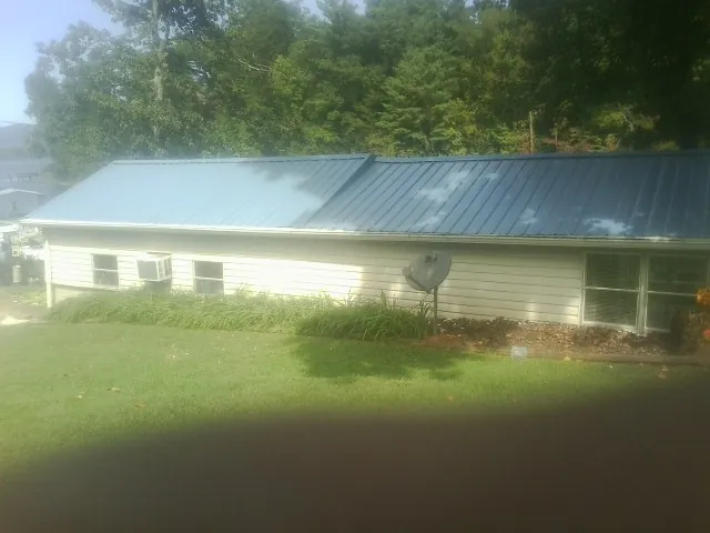 Blue metal roof running the length of a single story home in Cabin John