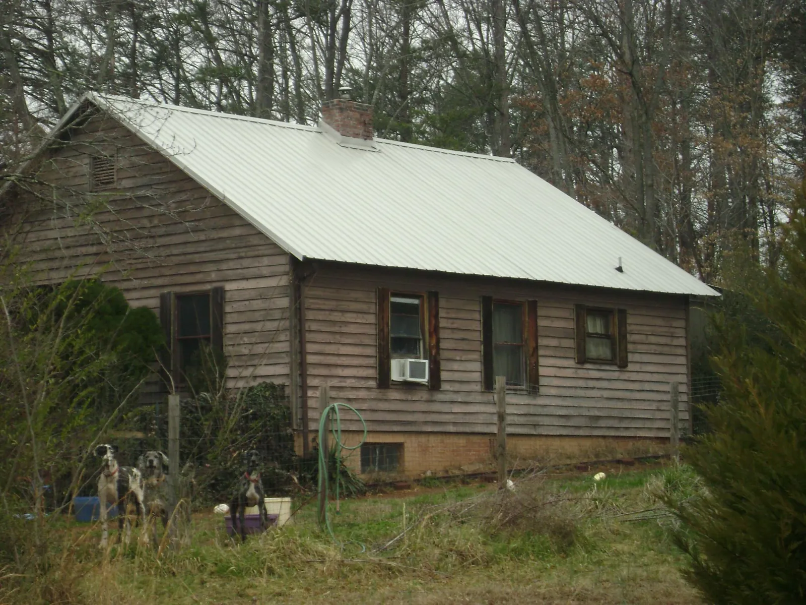 White metal roof on an old wood sided farmhouse, from a Asphalt Shingle Roof Repair job in Cabin John